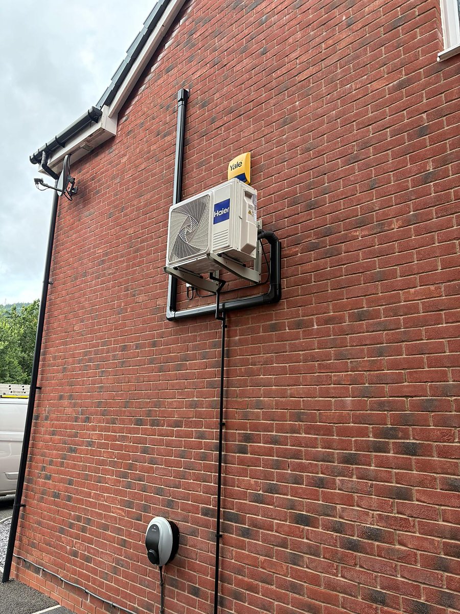 Domestic air conditioning outdoor unit fitted to a brick home